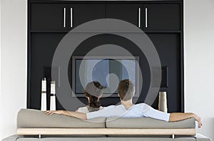 Couple Watching TV Together In Living Room