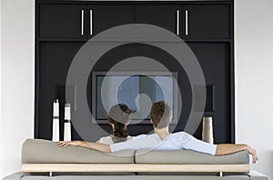 Couple Watching TV Together In Living Room photo