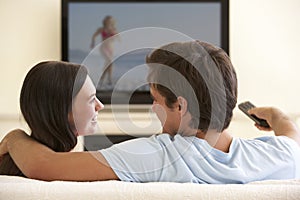 Couple Watching Widescreen TV At Home photo