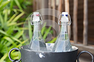 Couple of water bottles in ice bucket at hotel