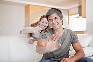 Couple waving at the camera