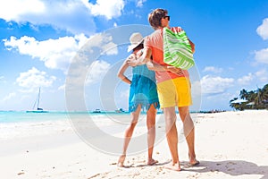 Couple wearing bright clothes on a tropical beach on Barbados