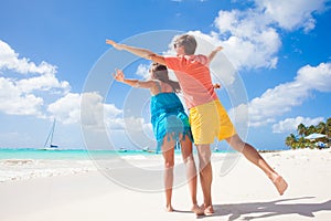 Couple wearing bright clothes on a tropical beach on Barbados