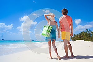 Couple wearing bright clothes on a tropical beach on Barbados