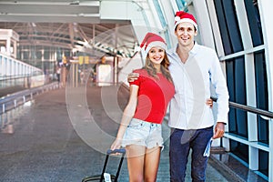 A couple wearing santa's hats