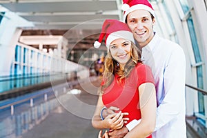 A couple wearing santa's hats