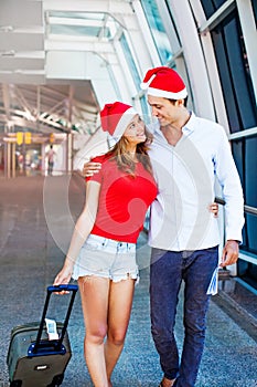 A couple wearing santa's hats