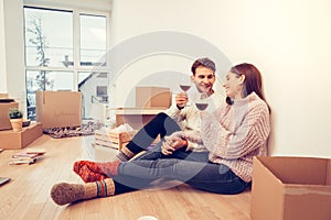 Couple wearing warm socks sitting on the floor after unpacking