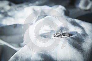 Couple wedding ring on wrinkly blanket on bed in valentine day.