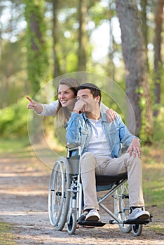 couple in wheelchair in autumn nature