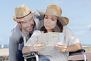 couple in wheelchair looking at map