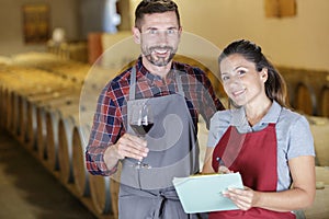 couple wine stewards doing stocktaking wine