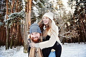 Couple in a winter forest. Weekends out of town