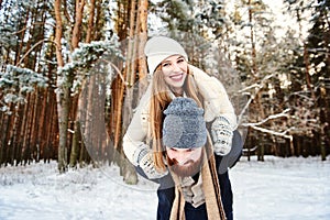 Couple in winterwear at the winter forest