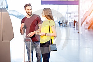 Couple withdrawing money at the airport photo