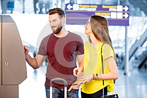 Couple withdrawing money at the airport photo