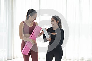 Couple woman enjoy making yoga or fitness exercises. Woman making yoga with coach or personal trainer for health or active