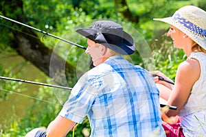 Couple, woman and man, with fishing rods sport angling