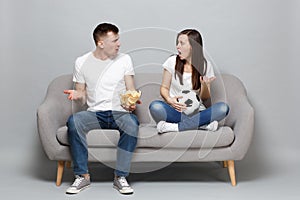 Couple woman man football fans cheer up support favorite team with soccer ball holding glass bowl of chips swearing