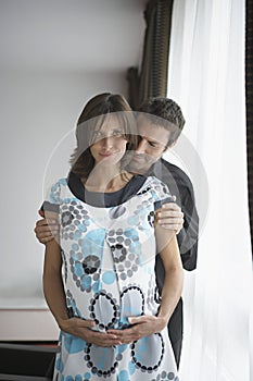 Couple With Woman Touching Her Belly