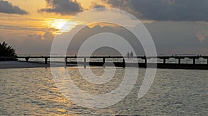 a couple in a wonderful view in the maldive island sunset