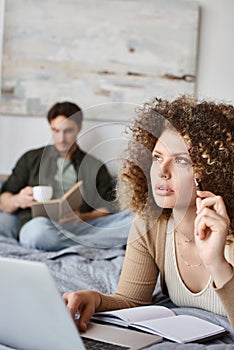 Couple working at home. Concerned woman