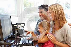 Couple working in home office with daughter