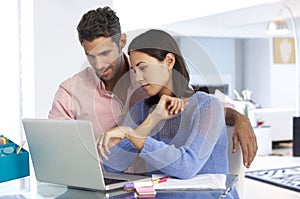 Couple Working At Laptop In Home Office