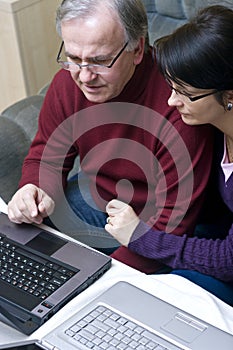 Couple working on laptops photo