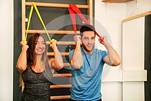 Couple working out exercise with stretch exercise rubber bands f