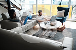 Couple Working And Playing With Laptop Computer At Home