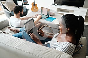 Couple Working And Playing With Laptop Computer At Home