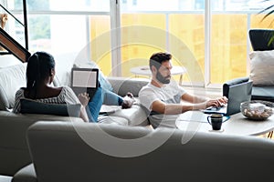 Couple Working And Playing With Laptop Computer At Home