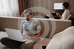 Couple Working And Playing With Laptop Computer At Home