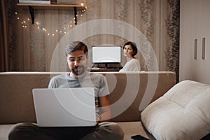 Couple Working And Playing With Laptop Computer At Home