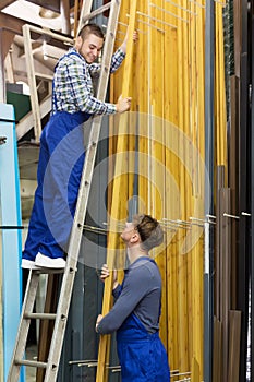 Couple of workmen inspecting PVC