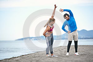 Couple worming up for a training on the beach