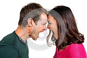 Couple yelling while standing head to head photo