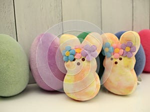 couple yellow pink hippie Easter peeps, pastel colored eggs,