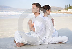 Couple, yoga and beach with meditation, peace and sitting on sand in morning with mindfulness in summer. Man, woman and