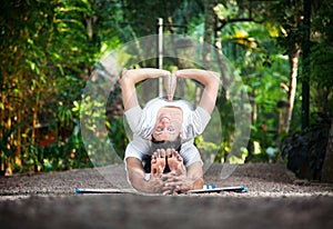 Couple yoga in garden