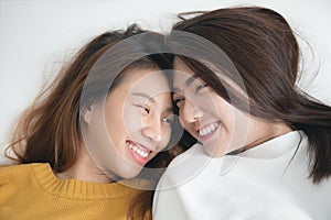 Couple of young asian women on white bed with happiness moment,lesbian couple concept