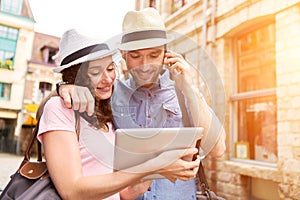 Couple of young attractive tourists discovering city on holidays