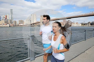 Couple of young joggers running on brooklyn promenade photo