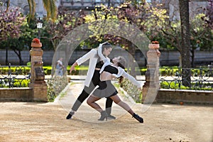 Couple of young Latin women dancing bachata in an outdoor park, performing different dance figures. Concept dances, urban, latin