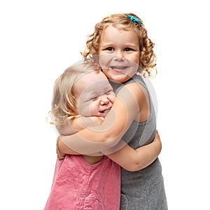 Couple of young little girls standing over isolated white background