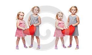 Couple of young little girls standing over isolated white background