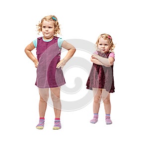 Couple young little girls standing over isolated white background