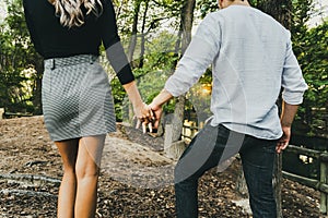 Couple of young lovers strolling leisurely through the countryside