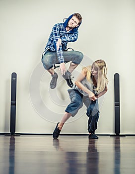 Couple of young man and woman dancing hip-hop